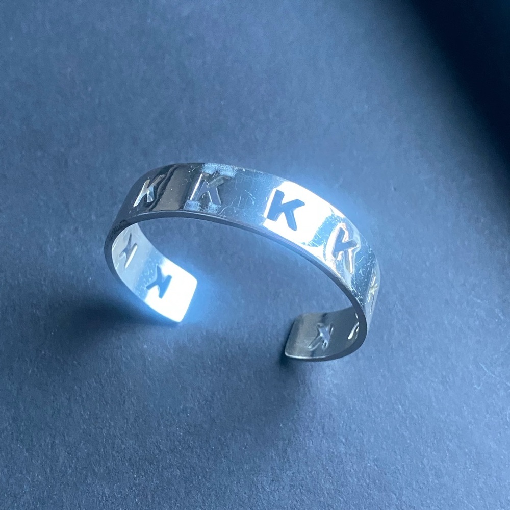 Rustic Cuff Silver toned skinny cuff bracelet featuring the letter “K”